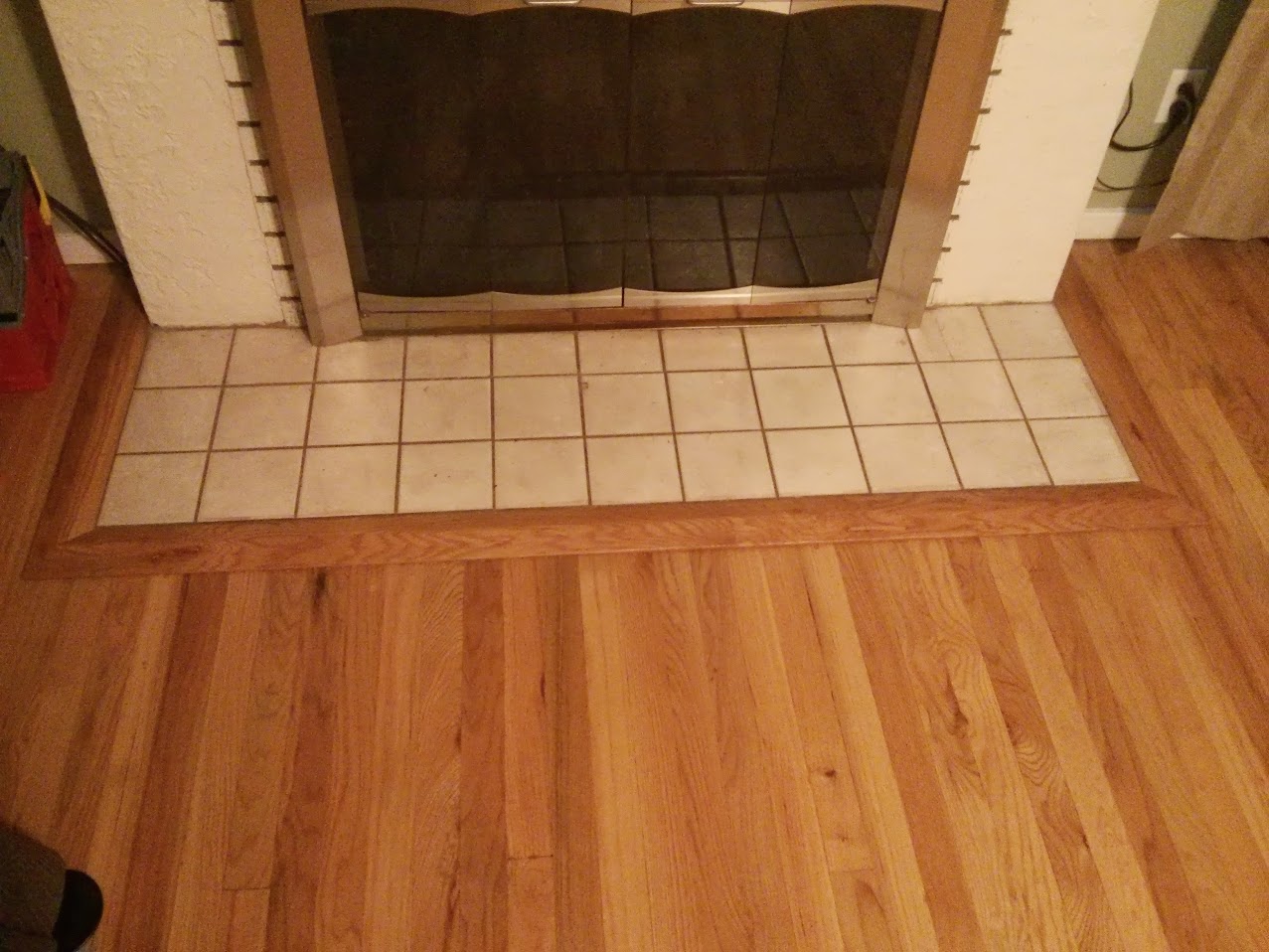 This floor had tile over the original hardwood flooring.  After removing the carpet I refinished the floor and installed this threshold to clean up the transition to the refinished hardwood floor.